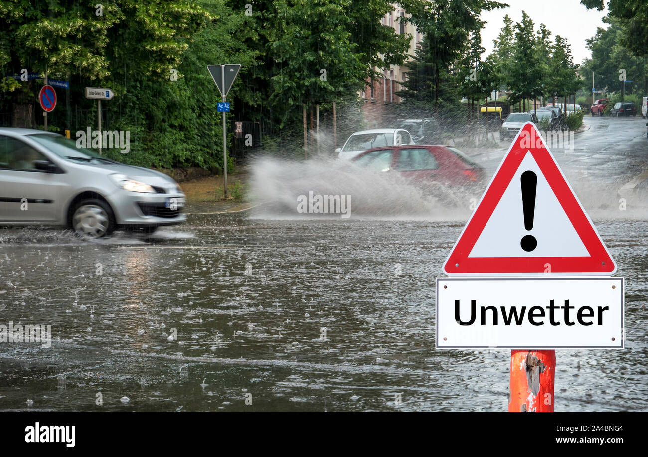 Bad weather warning sign flooded roads in German Stock Photo