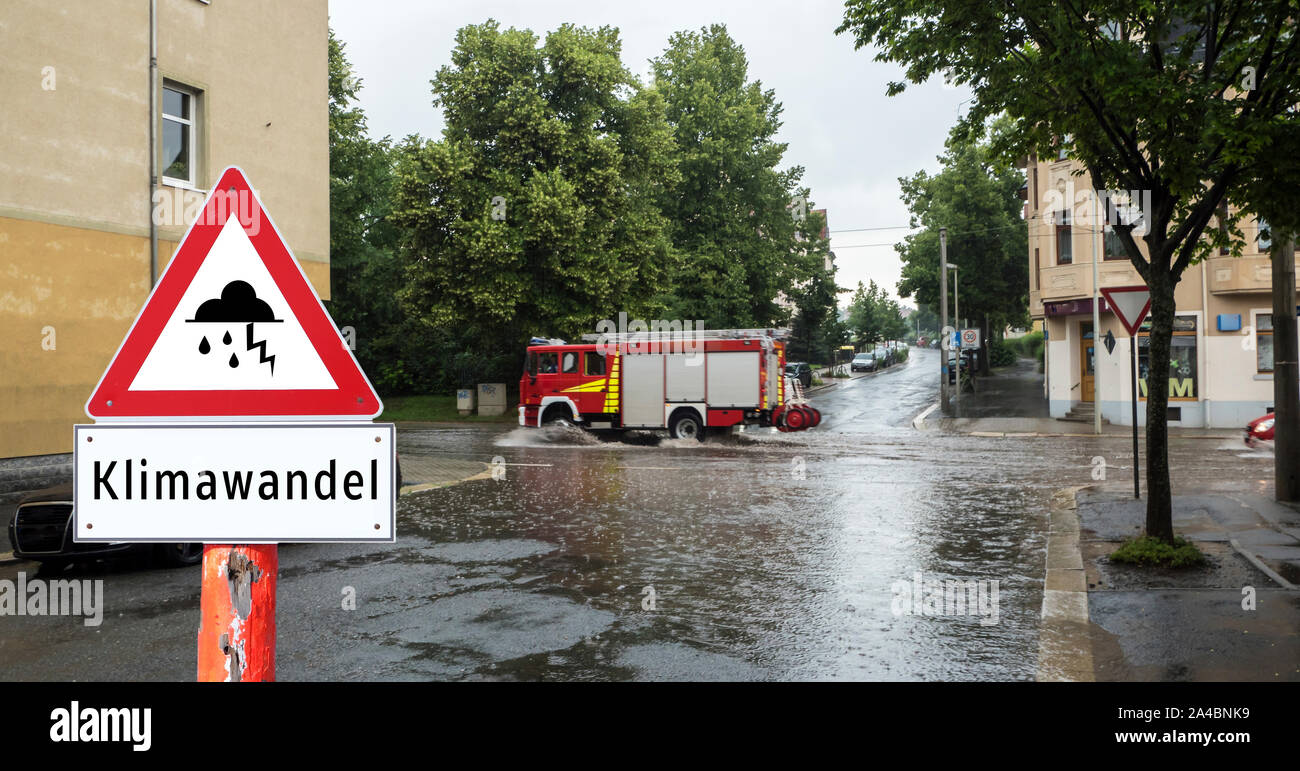 Climate change warning sign flooded roads in german Stock Photo - Alamy