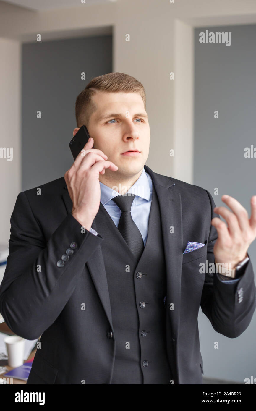 Businessman disputing on the phone Stock Photo