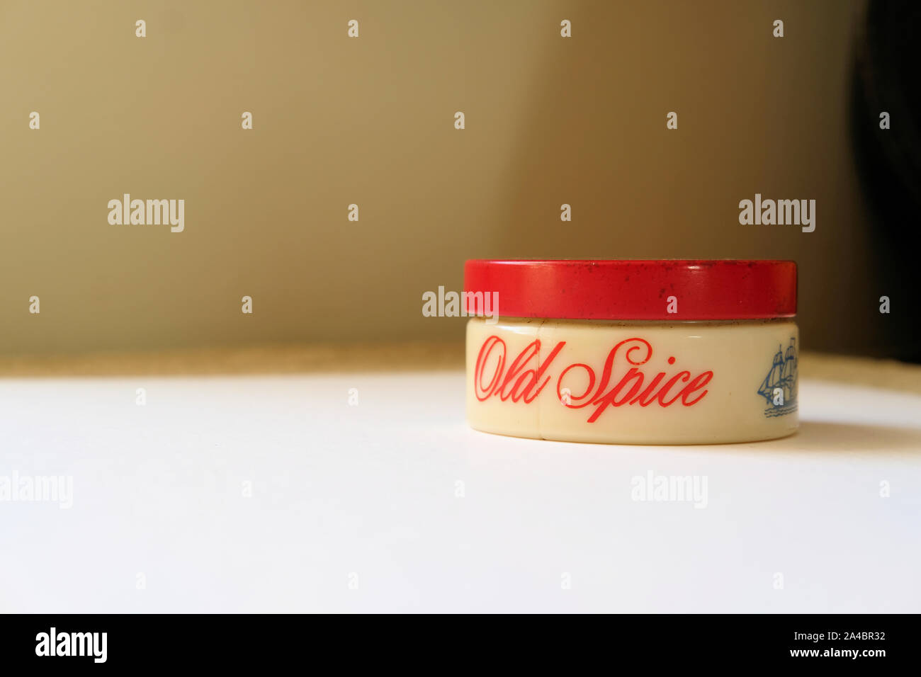 1960s glass jar of Old Spice brilliantine with a tin red top; classic grooming hair care products for men. Stock Photo