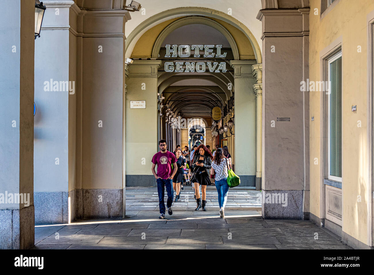 People walking thorough the elegant colonnaded arcades along Via Sacchi in Turin,Italy Stock Photo