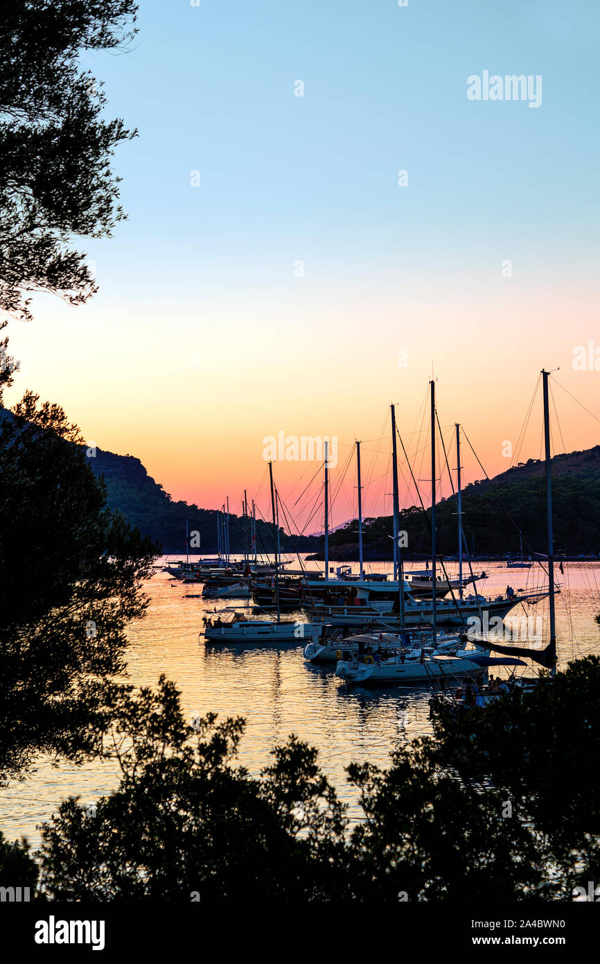 Sailboats anchored by Gemiler Island at sunset, Turkish Riviera, Turkey Stock Photo