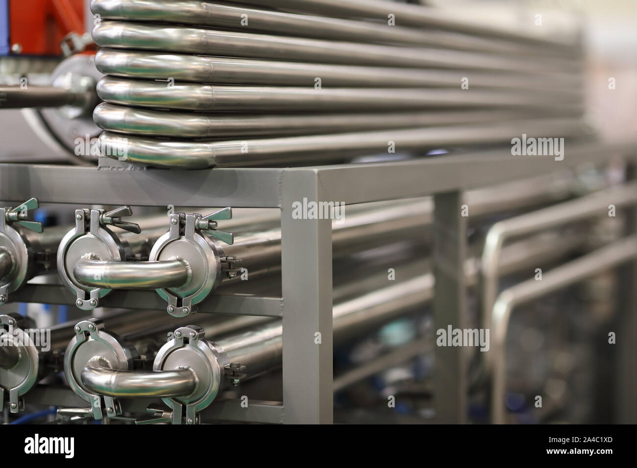 Stainless steel manufacturing equipment for the dairy industry. Selective focus. Stock Photo