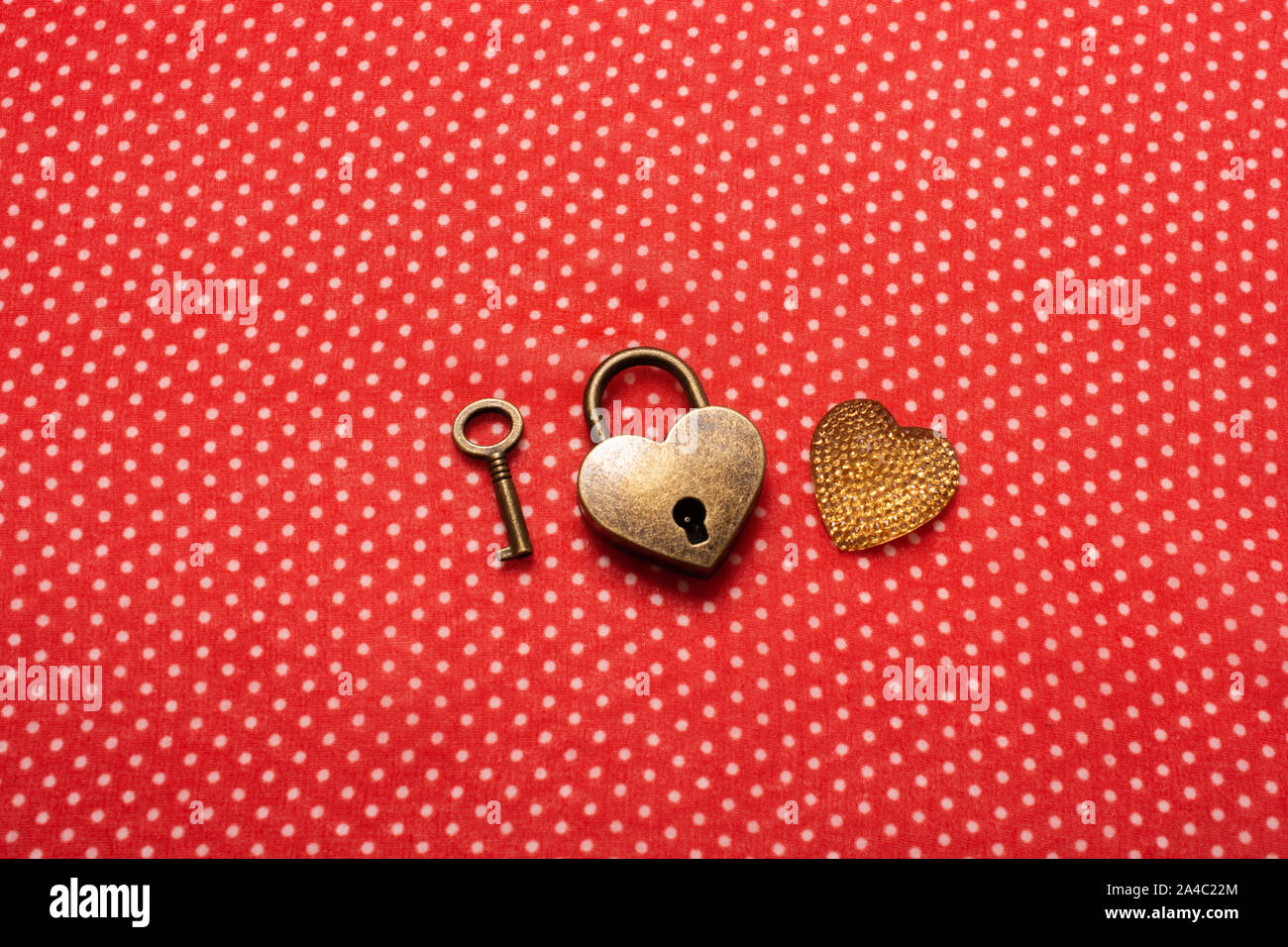 Heart shaped lock and key on a red background Stock Photo - Alamy