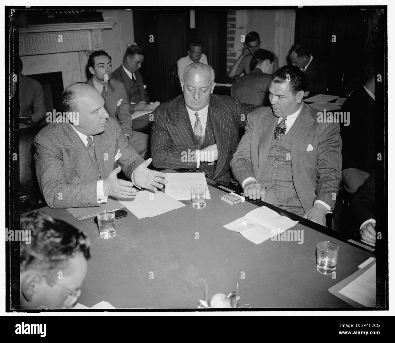 The Manassa Mauler appeals for repeal of law against shipment of eight films. Washington, D.C., May 25. Jack Dempsey, the Manassa Amuler and Col. John R. Kilpatrick, President of the Madison Square Garden Corp., were the main witnesses before a Senate Interstate Commerce Subcommittee today which is holding hearings upon a bill proposed by former amateur heavyweight champion Sen. W. Warren Barbour which would lift the present ban upon prize eight films in interstate commerce. Left to right: Senator Ernest L. Undeen, Chairman, Col. Kilpatrick, Jack Dempsey Stock Photo