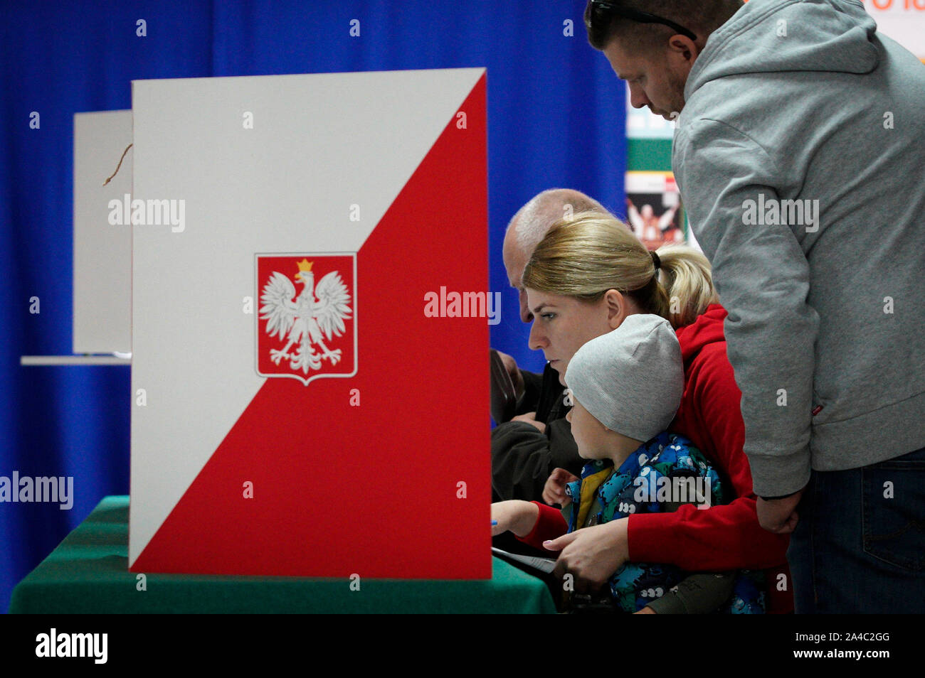 Warsaw, Poland. 13th Oct, 2019. People are seen at a voting station in Warsaw, Poland, on Oct. 13, 2019. The exit poll after the closing of the vote in Poland at 9 p.m. on Sunday indicated governing Law and Justice party (PiS) won 43.6 percent of the vote in the parliamentary election. Credit: Jaap Arriens/Xinhua/Alamy Live News Stock Photo