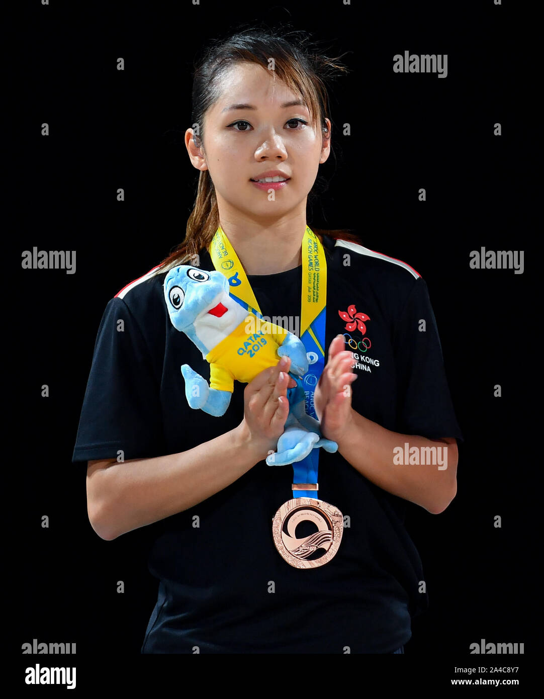 Doha, Qatar. 13th Oct, 2019. Lau Mo of China's Hong Kong pose for photos during the medal ceremony of the women's individual Kata event at the ANOC World Beach Games in Doha, Qatar, Oct. 13, 2019. Credit: Nikku/Xinhua/Alamy Live News Stock Photo