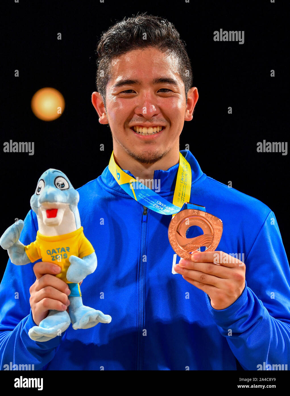 Doha, Qatar. 13th Oct, 2019. Gakuji Tozaki of the United States poses for photos during the medal ceremony of men's individual Kata event at the ANOC World Beach Games in Doha, Qatar, Oct. 13, 2019. Credit: Nikku/Xinhua/Alamy Live News Stock Photo
