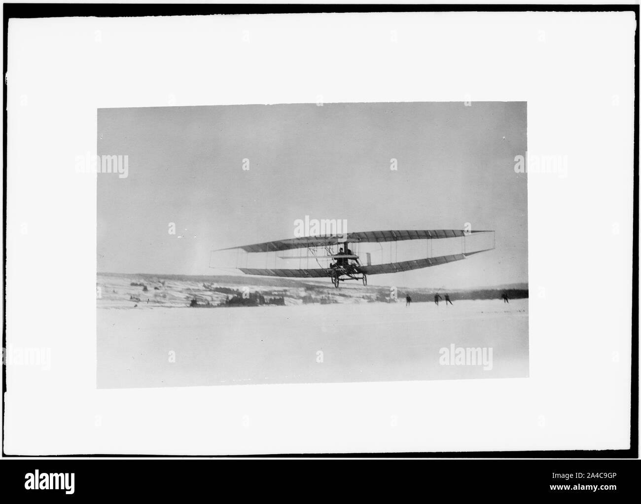 The Silver Dart, one of the Aerial Experiment Association's early airplanes, in flight over the frozen Bras d'Or Lake on Cape Breton Island Stock Photo