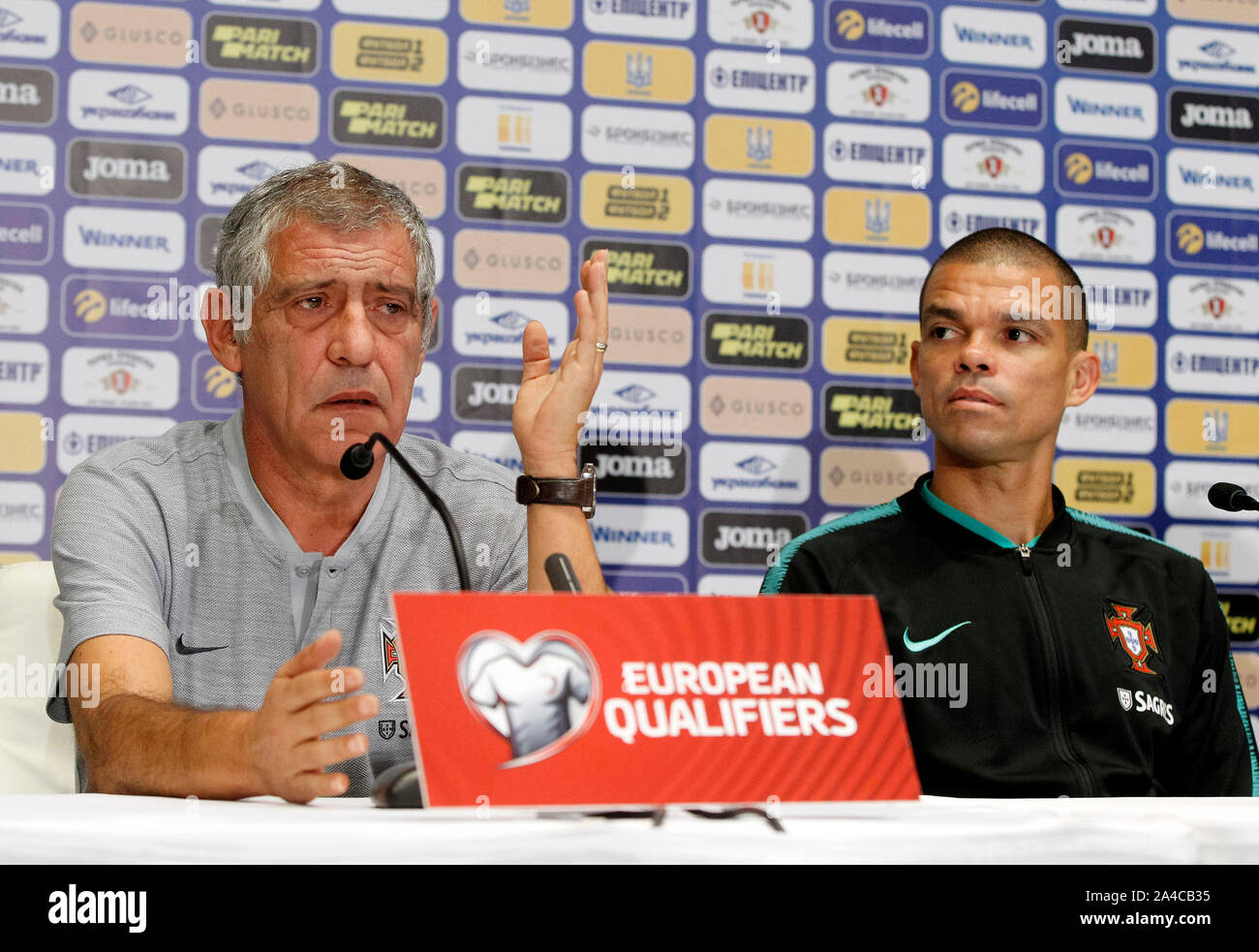 Kiev, Ukraine. 13th Oct, 2019. Portugal head coach Fernando Santos (L) and player Pepe (R) attend a press conference at the NSC Olimpiyskiy stadium in Kiev.Portugal and Ukrainian national teams face in the UEFA Euro 2020 qualifier football match on 14 October 2019. Credit: SOPA Images Limited/Alamy Live News Stock Photo