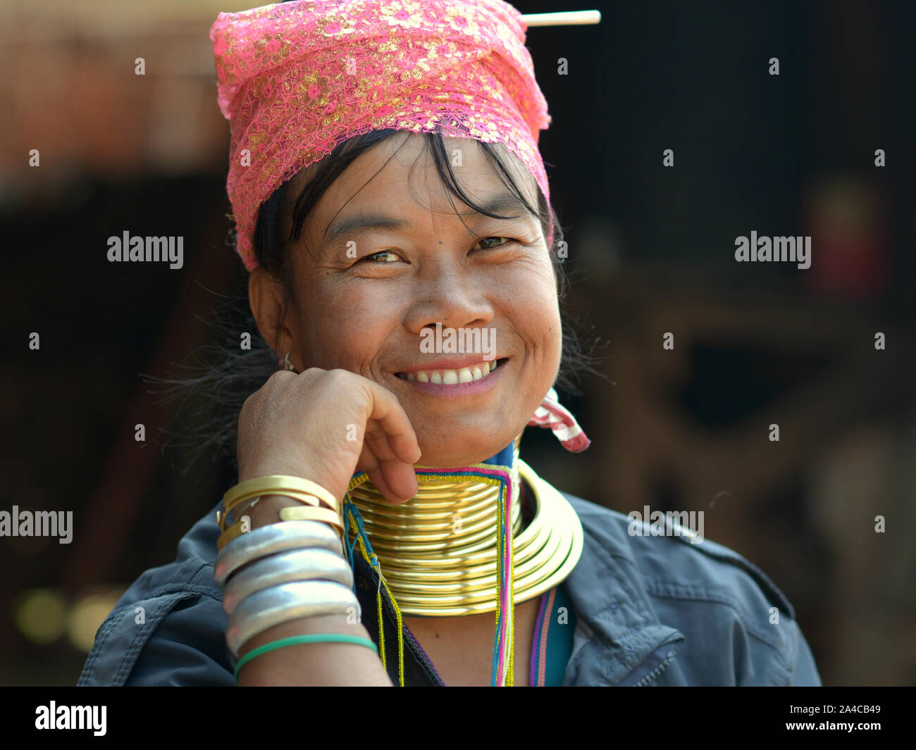 Myanmarese Kayan Lahwi woman (“giraffe woman”) with tribal brass neck rings/coils smiles for the camera. Stock Photo