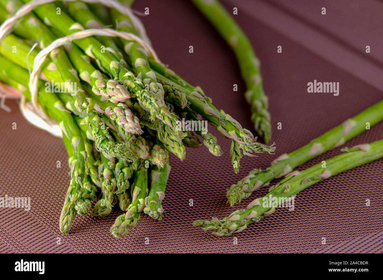 Fresh green asparagus on wooden table Stock Photo