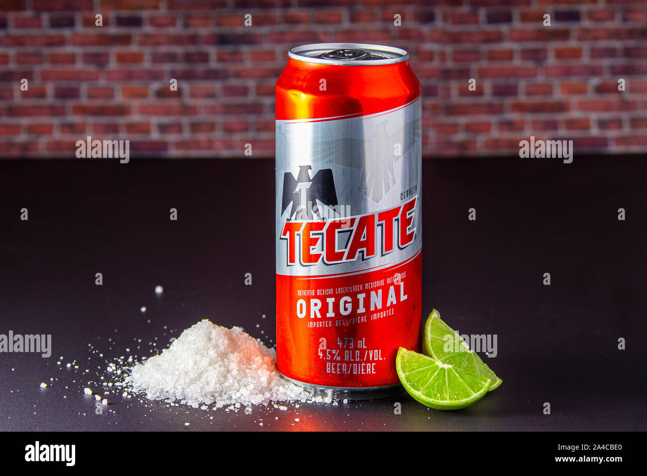 Tecate beer can with salt and limes on the side. Stock Photo