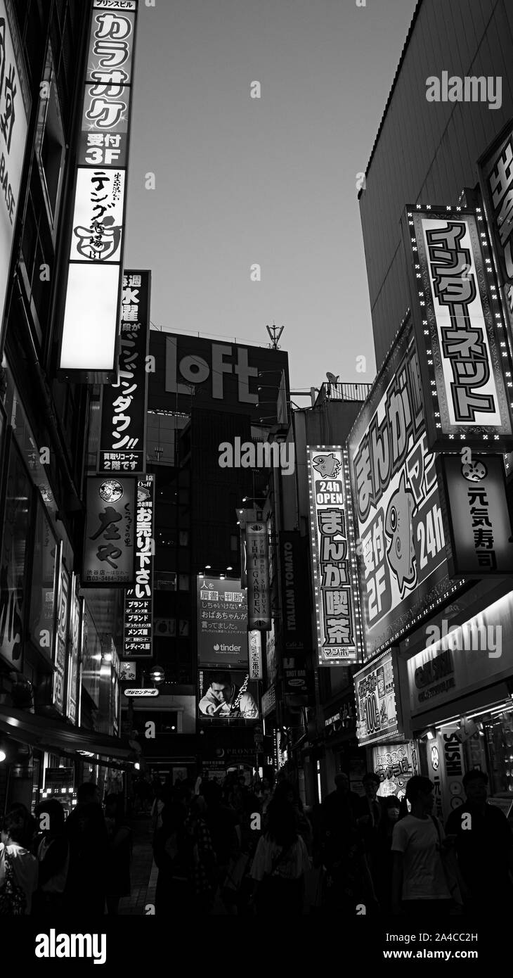 Shibuya night entertainment billboards lights street neon black white Stock Photo