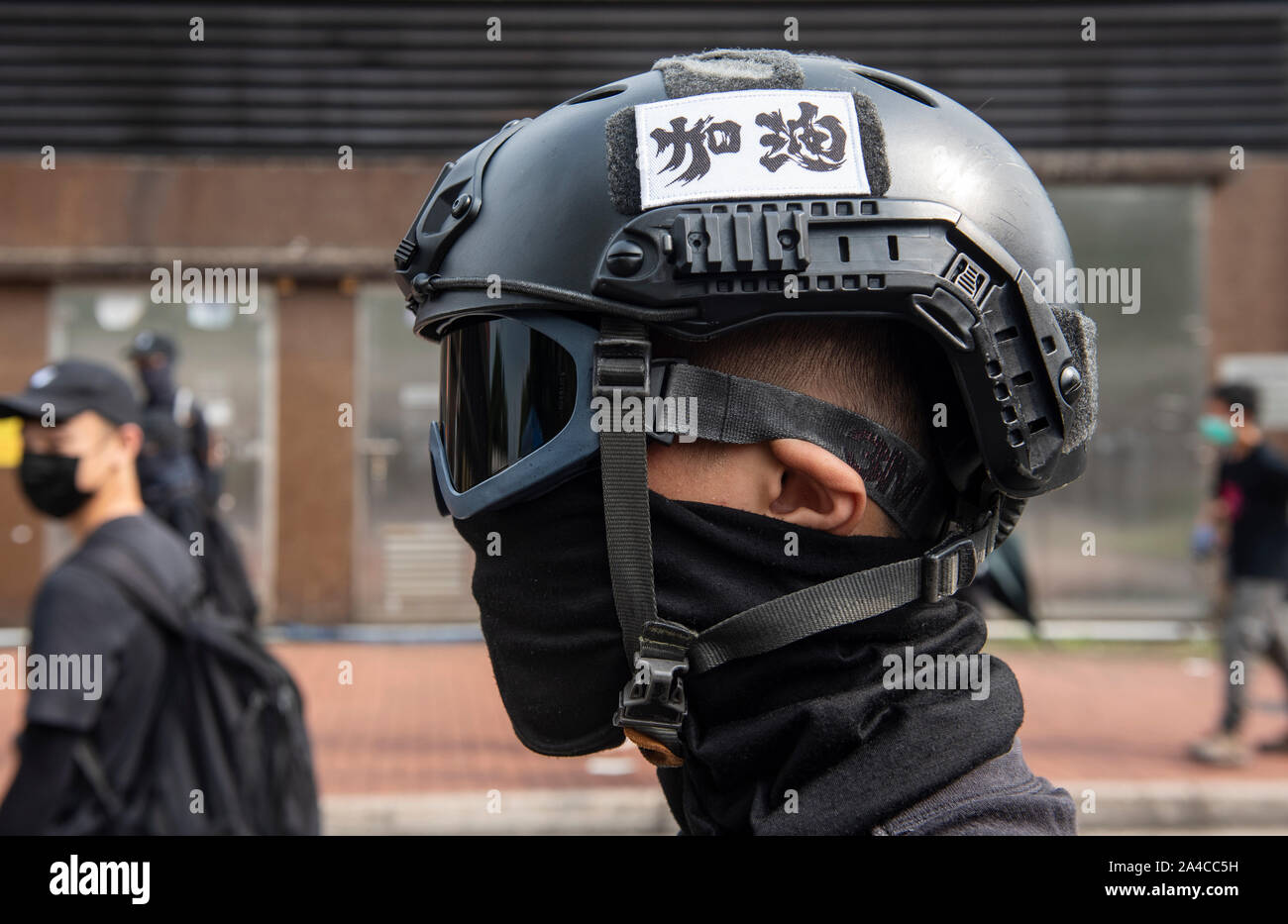 Hong Kong, China. 13th Oct, 2019. A protester wears a helmet with the words Hong  Kong in Chinese characters during the demonstration.Hong Kong's government  introduced an anti-mask law which bans people from