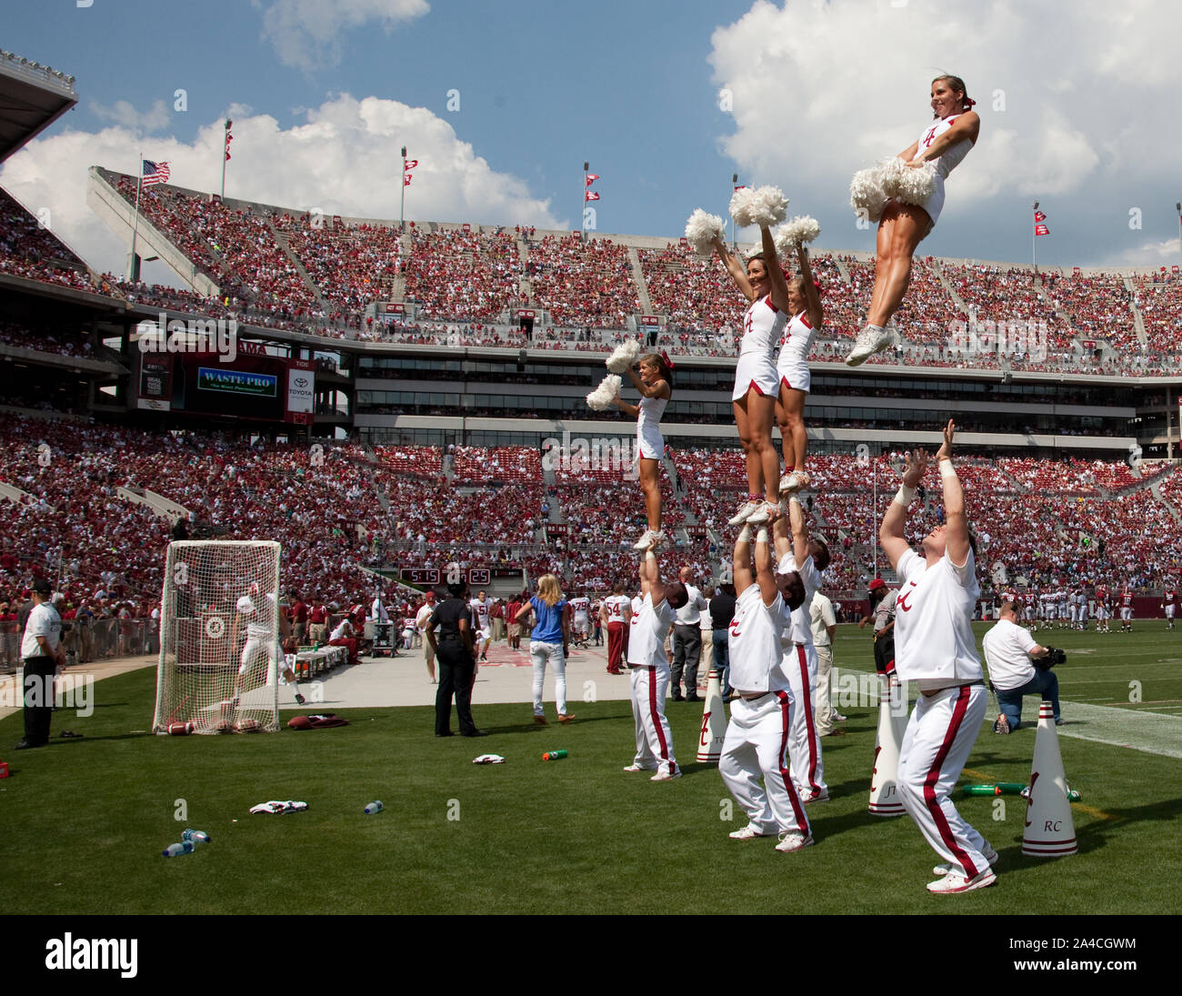 The cheerleaders are amazing to watch. The boys throw the girls into the air as they cheer on their winning team. University of Alabama football game, Tuscaloosa, Alabama Stock Photo