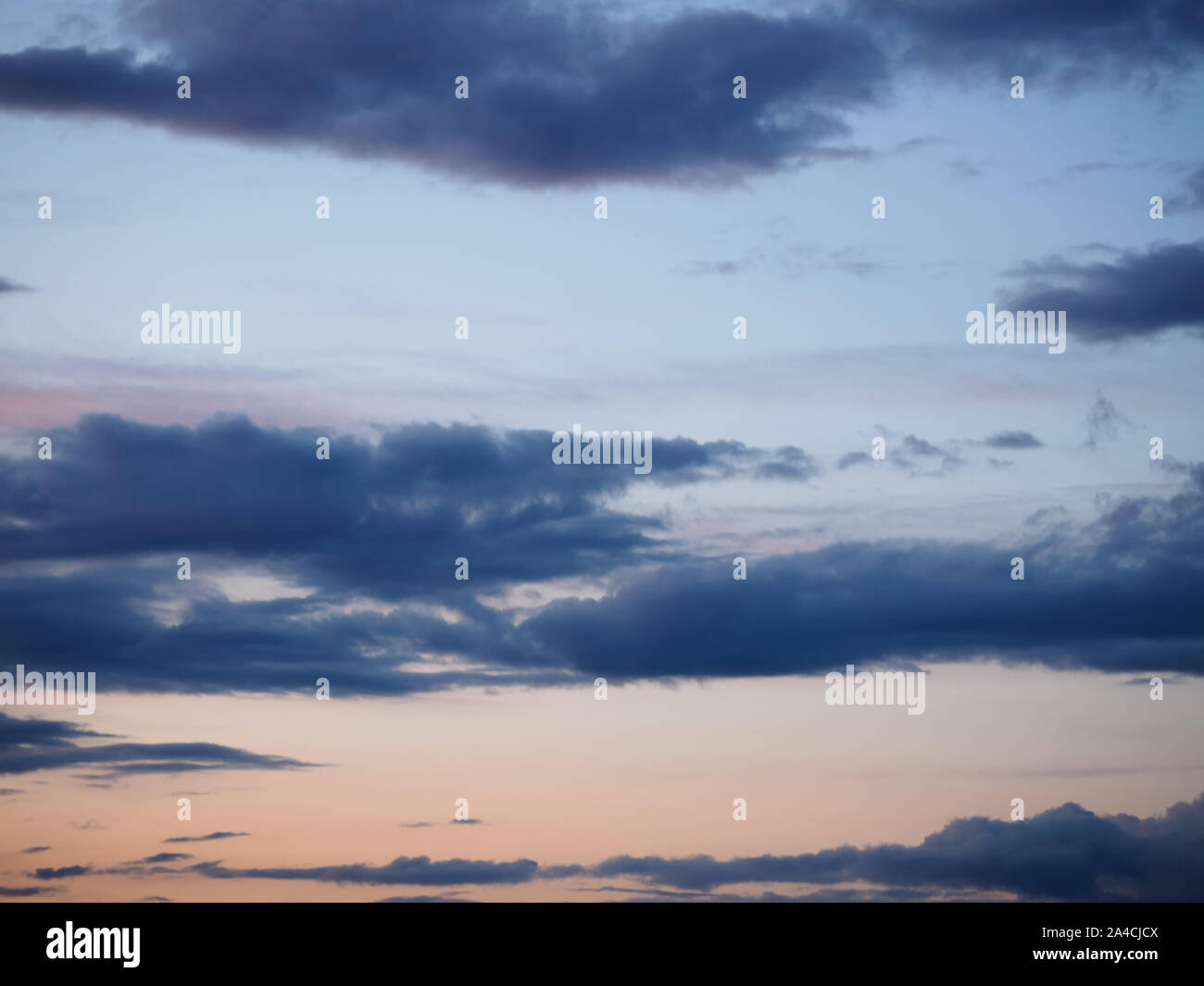 Dark gray clouds on a blue sky background Stock Photo