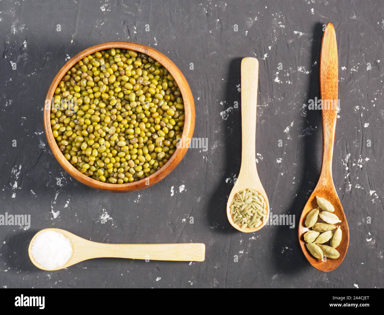 Green gram and spices on a black concrete background. Indian cuisine ingredients Stock Photo