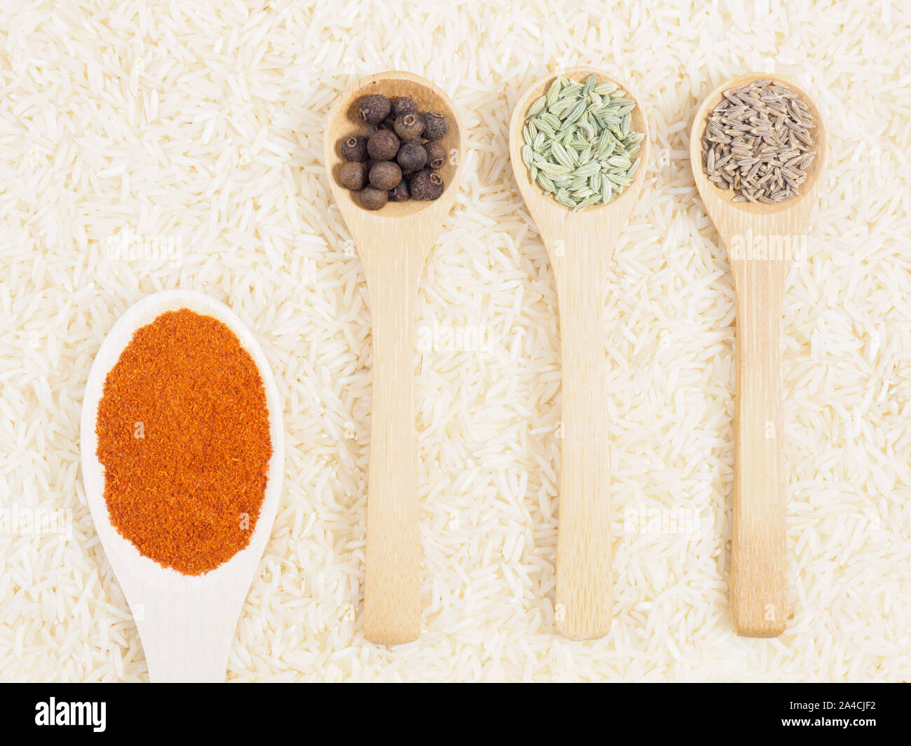 Spices in spoon on background from basmati rice chili pepper