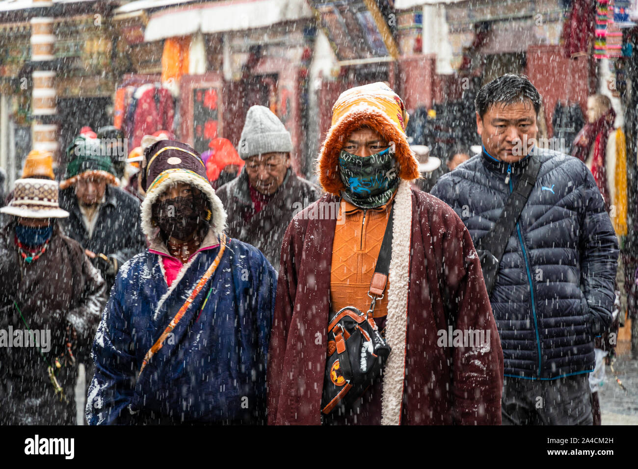 Lhasa, China - December 26 2018: Tibetan Buddhists devouts perform a kora around the  Jokhang temple  along Barkhor street in Lhasa old town in Tibet Stock Photo