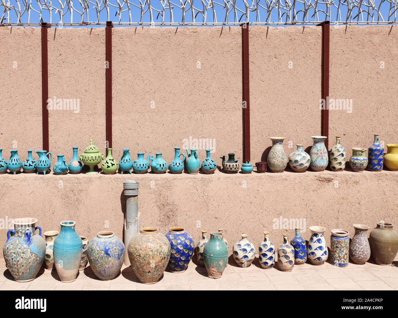Traditional iranian souvenirs - colorful clay pots and jugs, Yazd, Iran Stock Photo