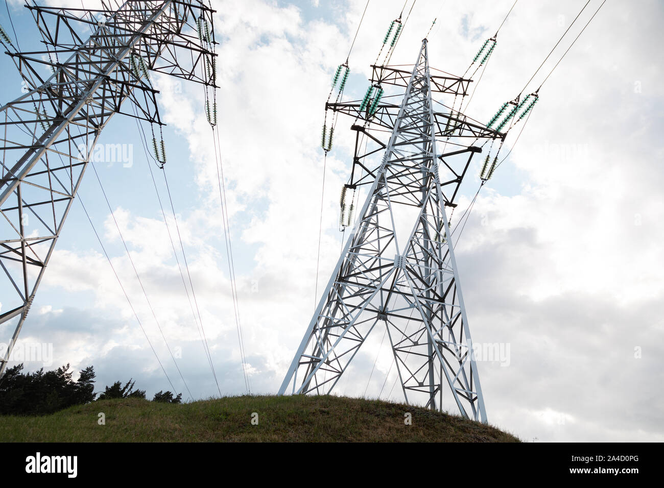 Two transmission towers in front of cloudy sky Stock Photo - Alamy