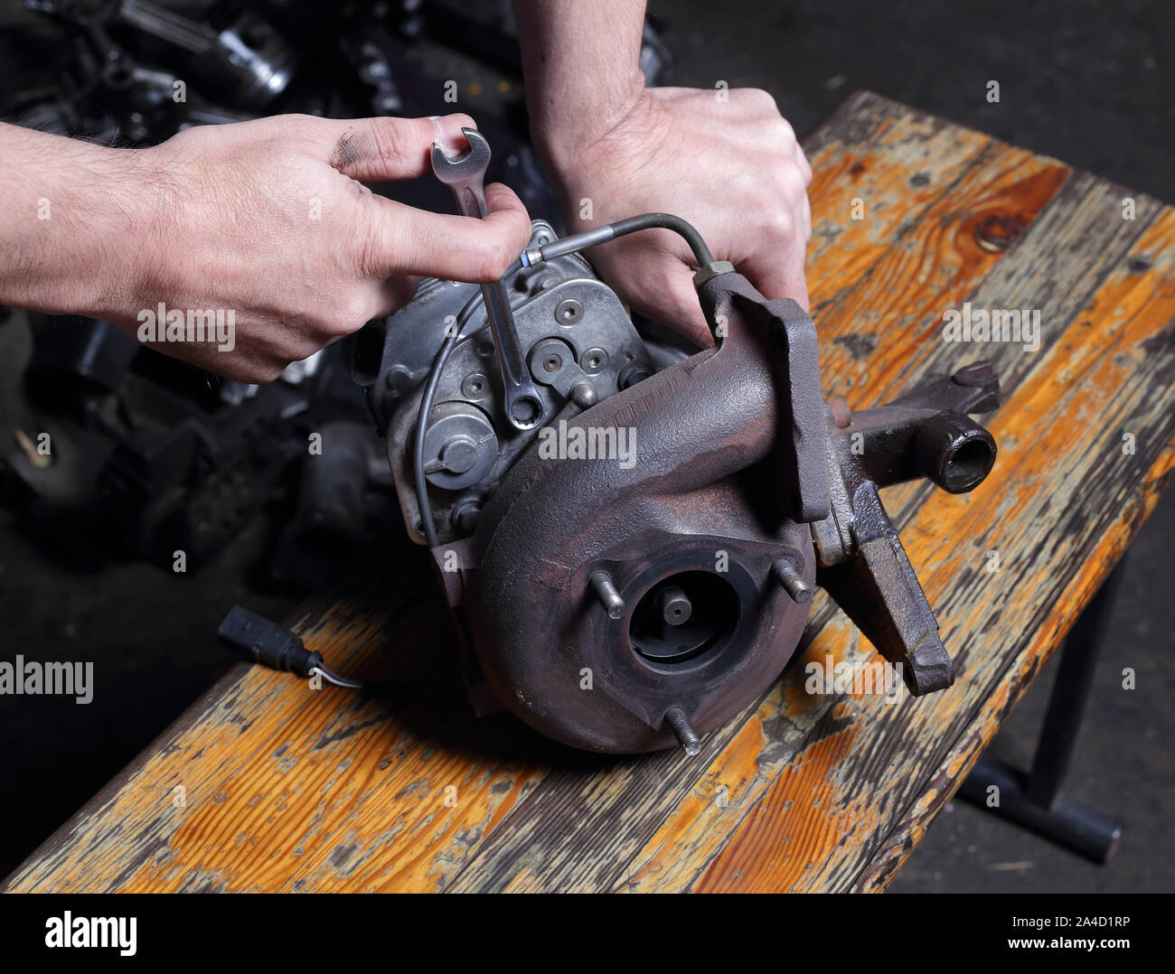 Car service Engine repair, mechanic hands with wrench turns off