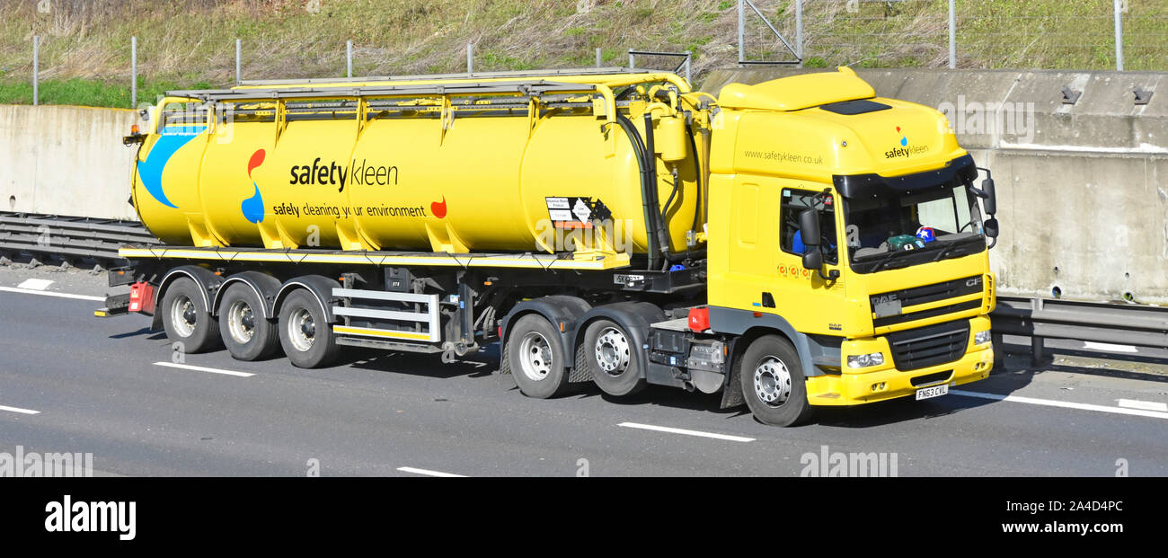 Yellow Safety Kleen industrial waste management business hgv lorry truck & tanker trailer Low Hazard Hazchem plates raised economy axle uk motorway Stock Photo