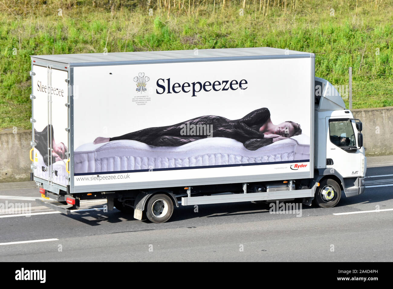 Sleepeezee business & manufacturer of mattresses using side of supply chain delivery lorry truck to advertise a fashion model posing on a mattress uk Stock Photo
