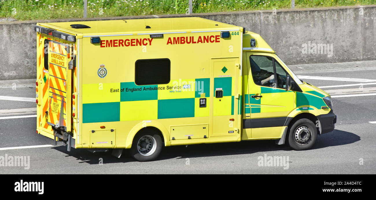 Looking down from above side front & roof view East of England Emergency Ambulance Service NHS 999 healthcare vehicle & crew M25 motorway England UK Stock Photo