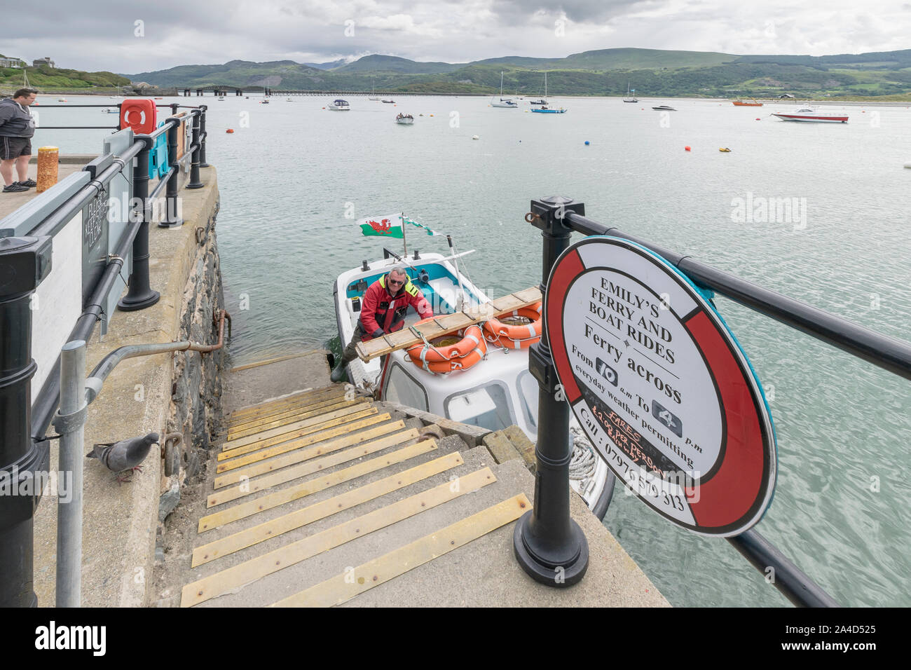 Emily's Ferry and boat rides crossing Barmouth Harbour in Gwynedd on the North Wales coast Cardigan Bay Stock Photo