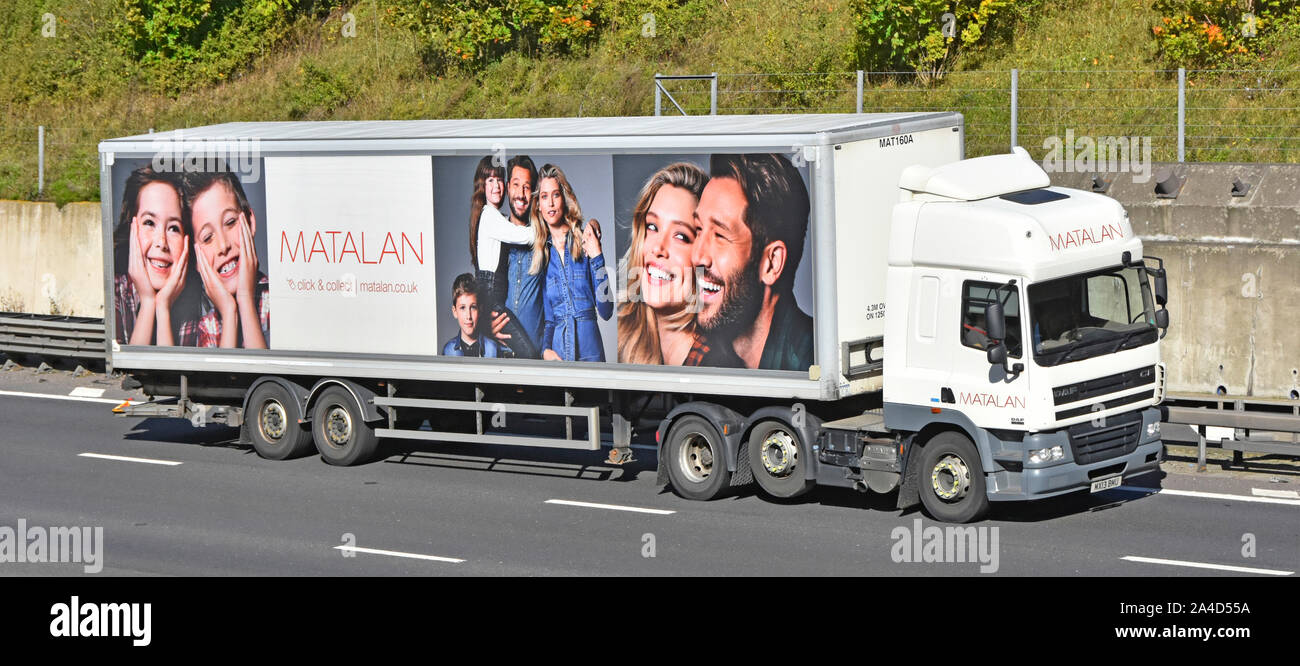Matalan click & collect brand advertising & fashion photography  side view of supply chain delivery trailer behind DAF hgv lorry truck on UK motorway Stock Photo
