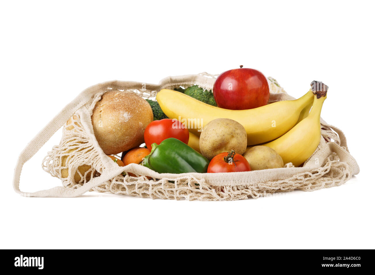 Reusable eco-friendly strip shopping bag full of various food - fruits, vegetables and bread. Isolated on white background. Stock Photo