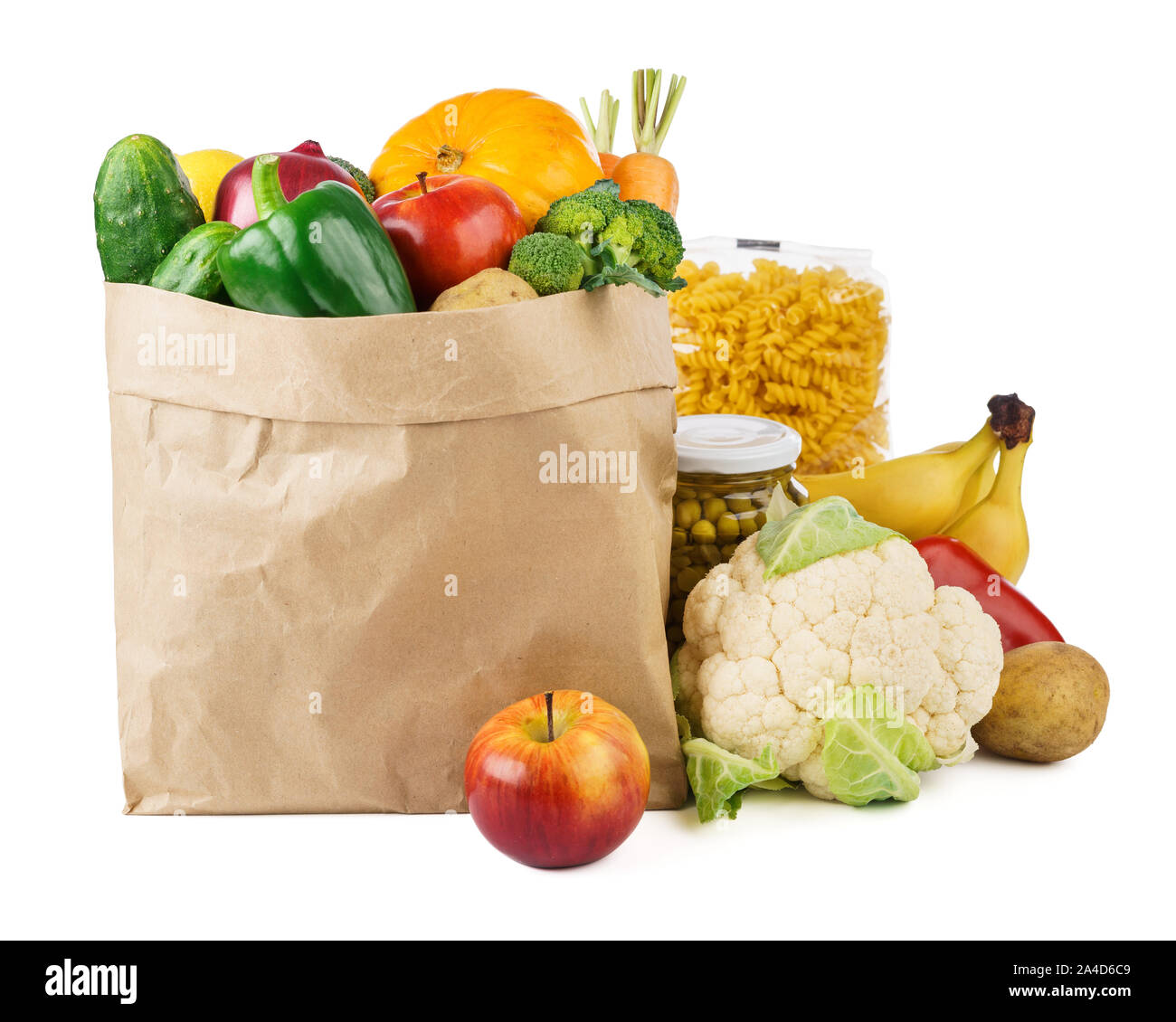 Paper bag with various food - fresh vegetables, fruits, canned goods and bread. Food delivery or donations. Stock Photo