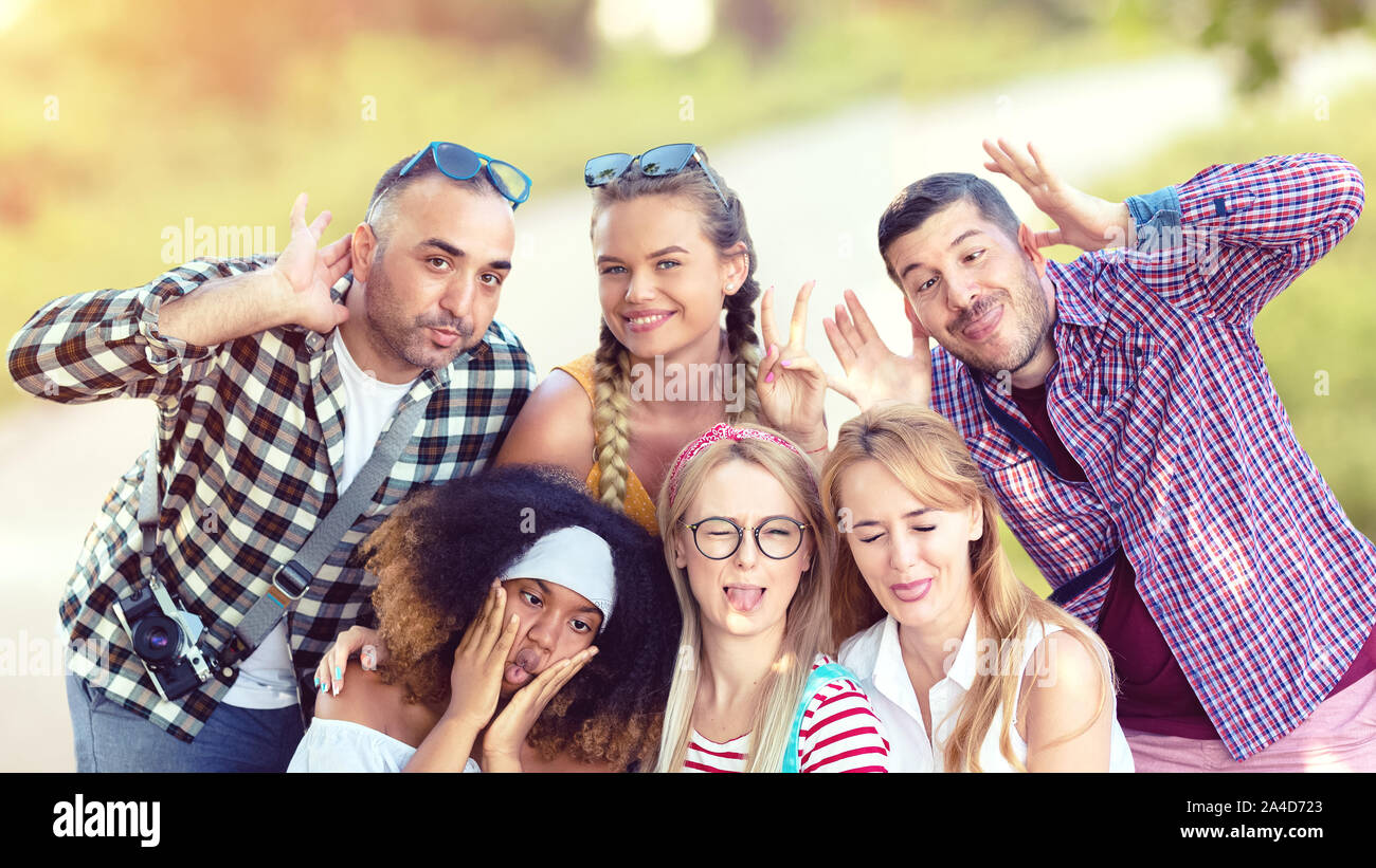Happy multiracial best friends taking selfie outdoor with funny faces Stock Photo