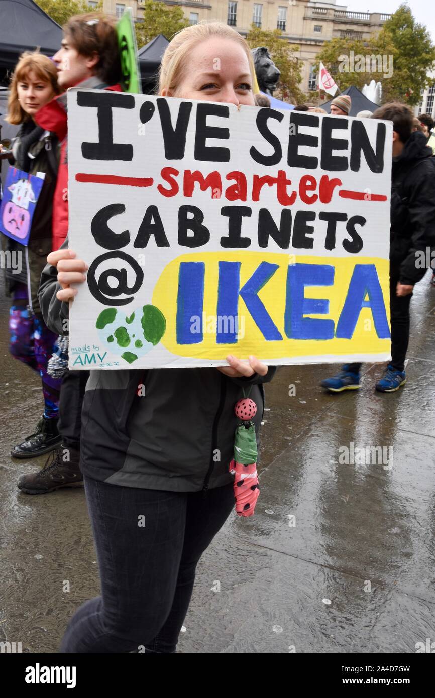 Protester holding a placard which says "I've seen smarter Cabinets at IKEA", Extinction Rebellion Protest, Day Six, Trafalgar Square, London. UK Stock Photo