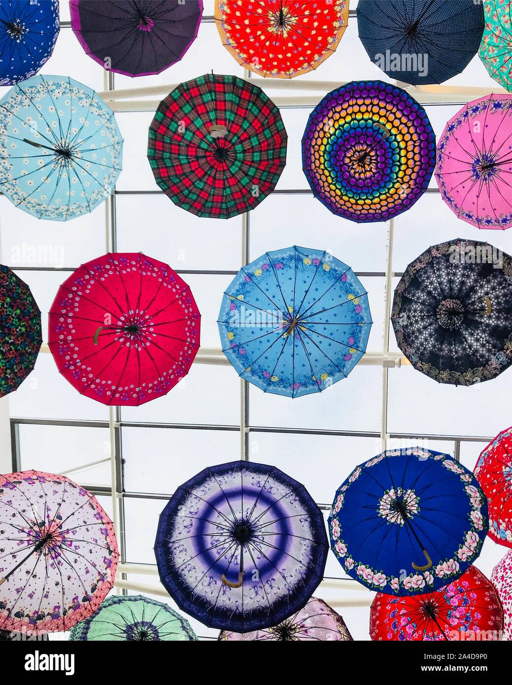 Low angle view of umbrellas hanging in city, Kuwait Stock Photo