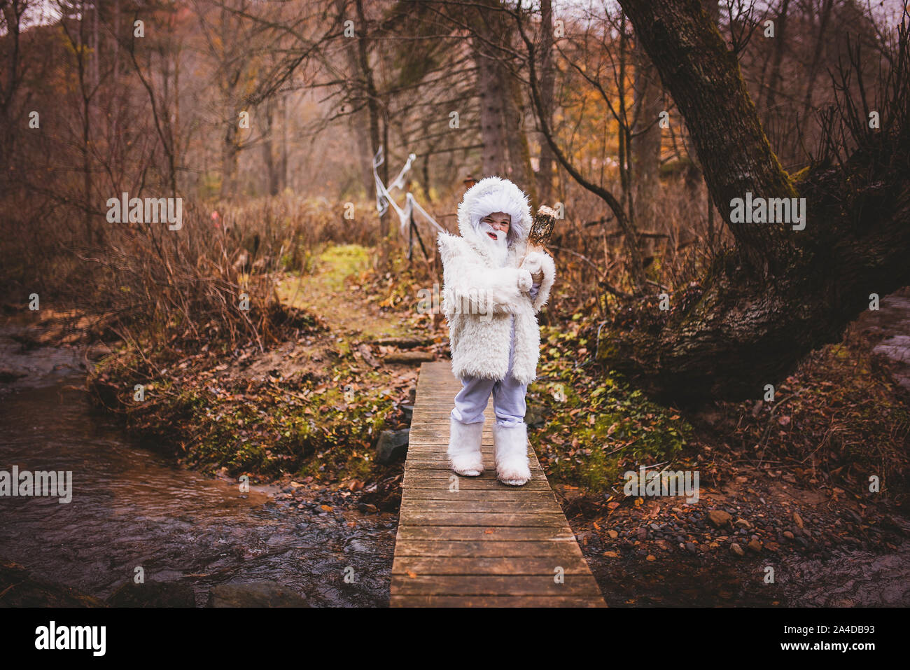 Boy crossing a bridge dressed as a white yeti for Halloween, United states Stock Photo