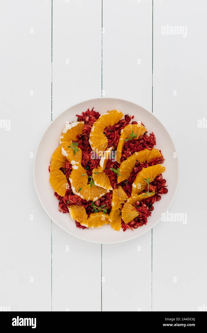 Plate of Carrot and orange salad with pomegranate Stock Photo