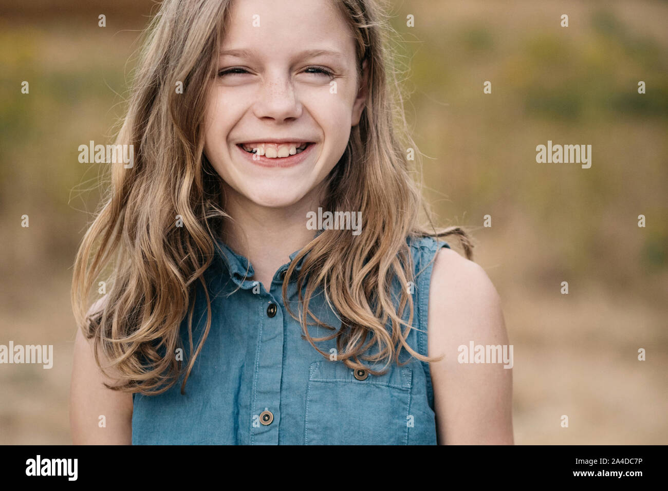 Portrait of a smiling girl with long hair, Netherlands Stock Photo