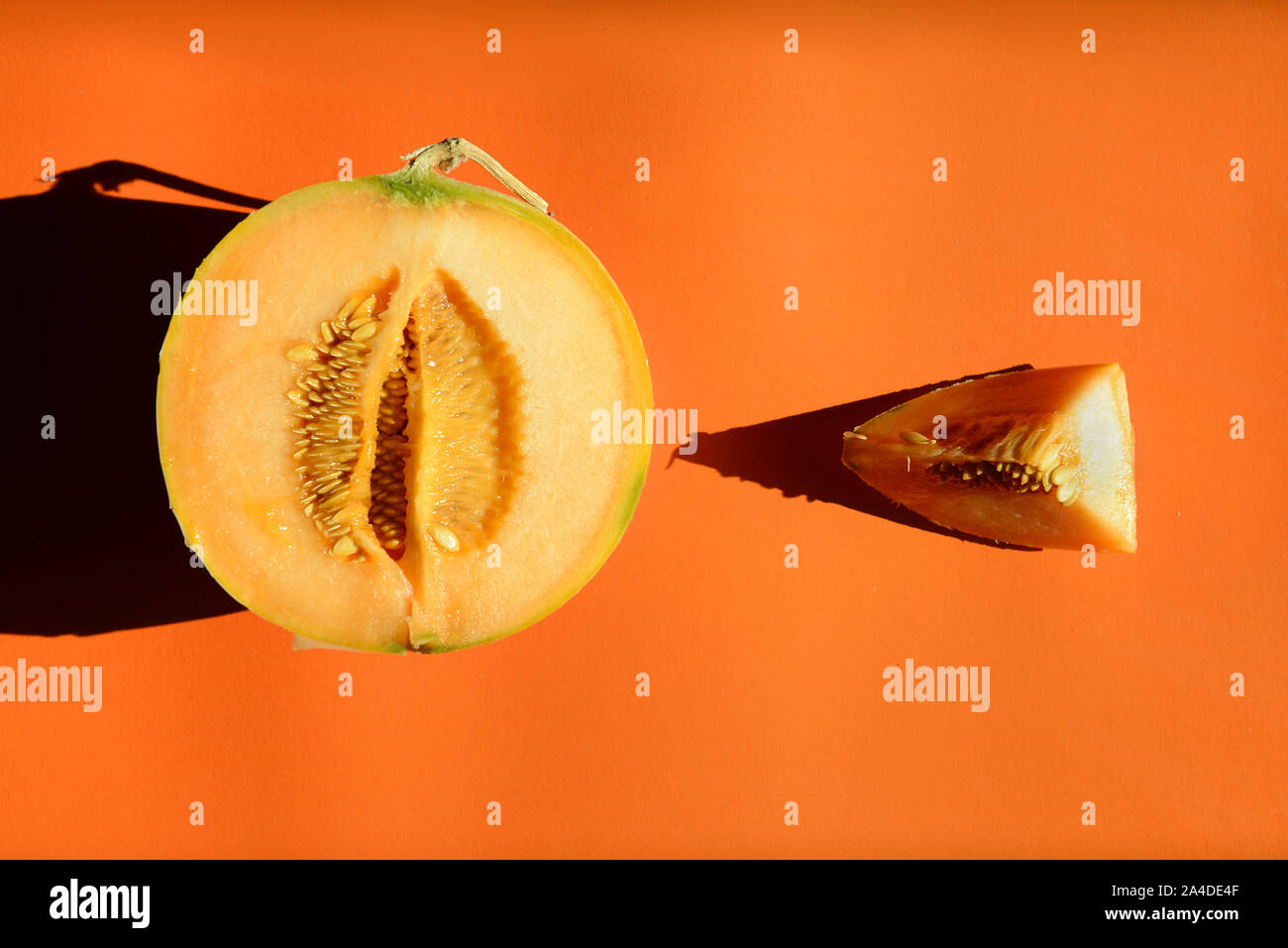Melon clices sliced  on orange background Stock Photo