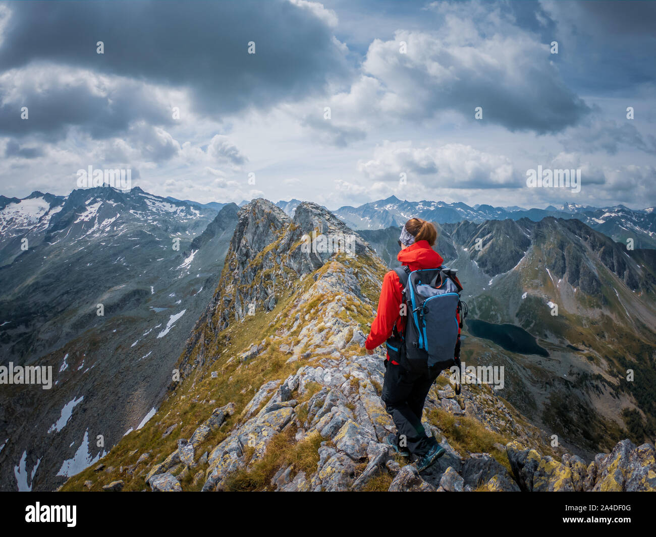 Woman hiking along ridge of a mountain, Austrian Alps, Bad Gastein, Salzburg, Austria Stock Photo