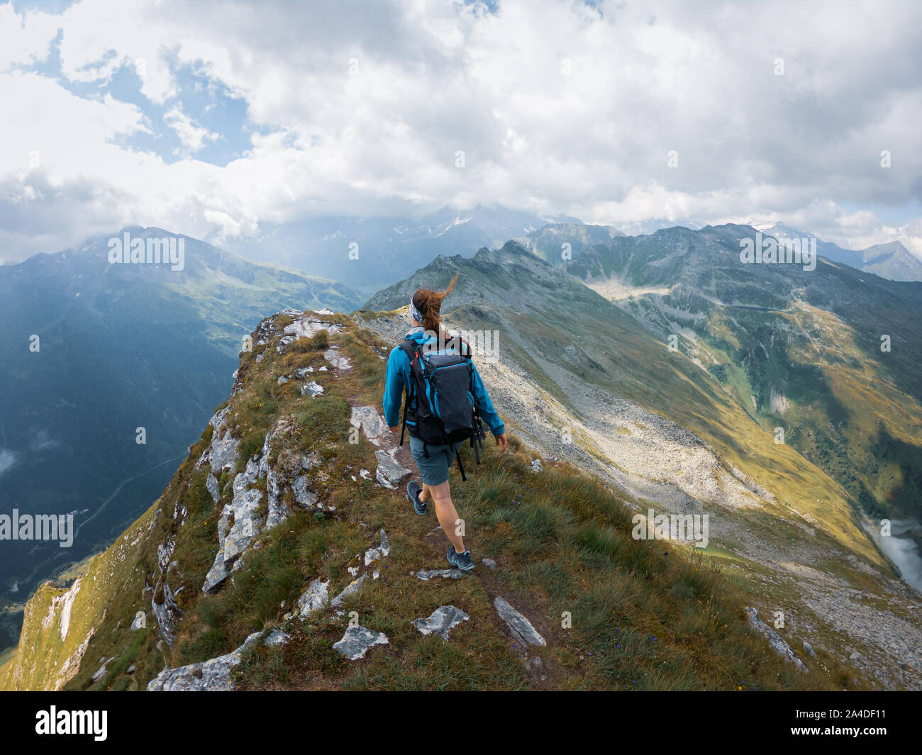 Woman hiking to the top of a mountain hi-res stock photography and ...