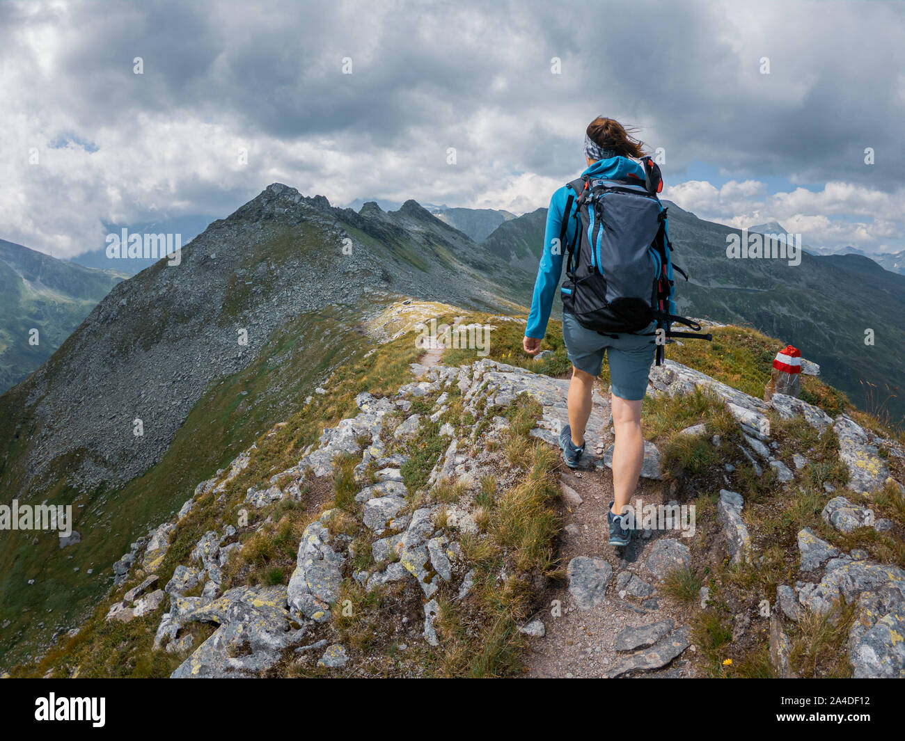 Woman hiking to the top of a mountain hi-res stock photography and ...