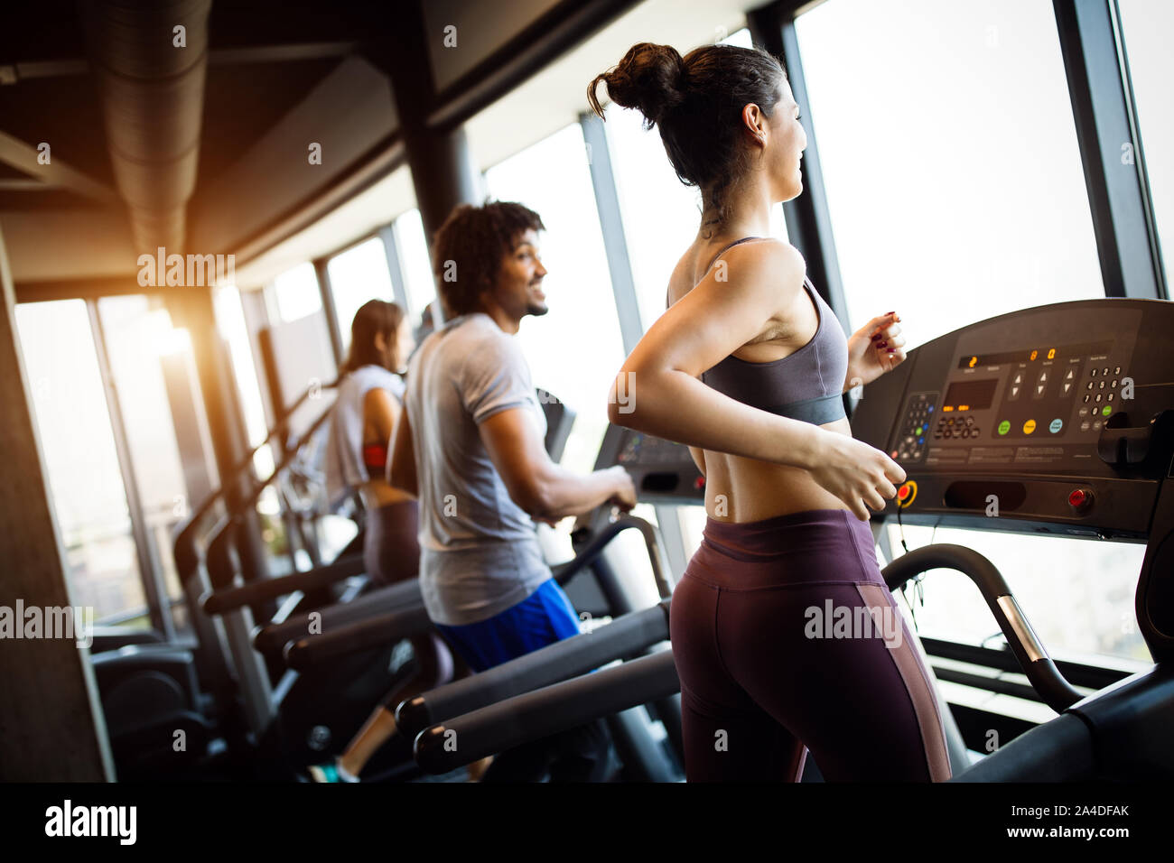 Group of young people running on treadmills in modern sport gym Stock ...