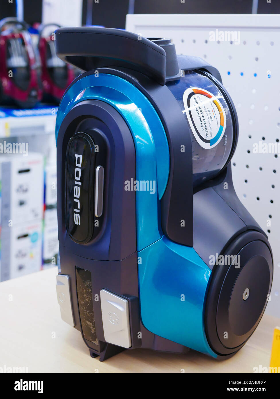 blue vacuum cleaner. at the store counter. stand on a shelf of a store. Stock Photo