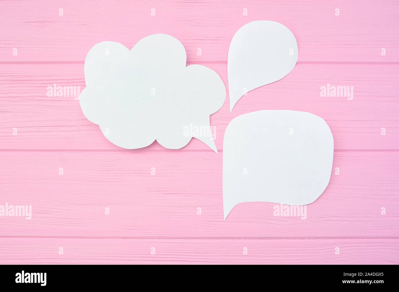 Collection paper speech bubble. Dialog questions and answer on a pink wooden background Stock Photo