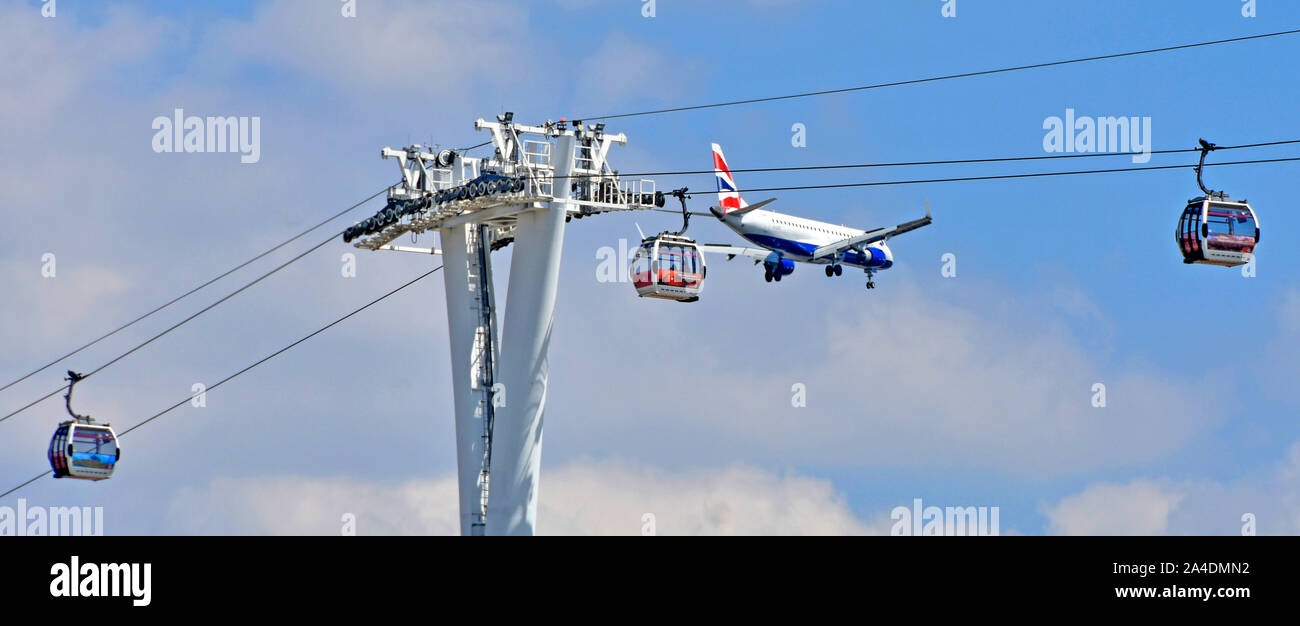 Emirates cable car crossing River Thames at North Greenwich British Airways jet aeroplane descending to land at nearby London City Airport England UK Stock Photo