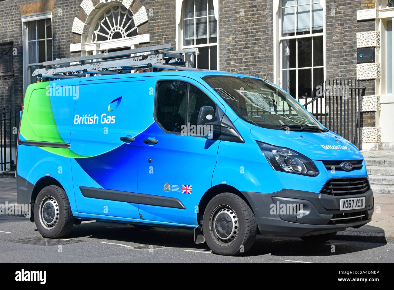 Blue Centrica British Gas plc home  customer energy service provider via engineers Ford transit van in street at a consumer property London England UK Stock Photo