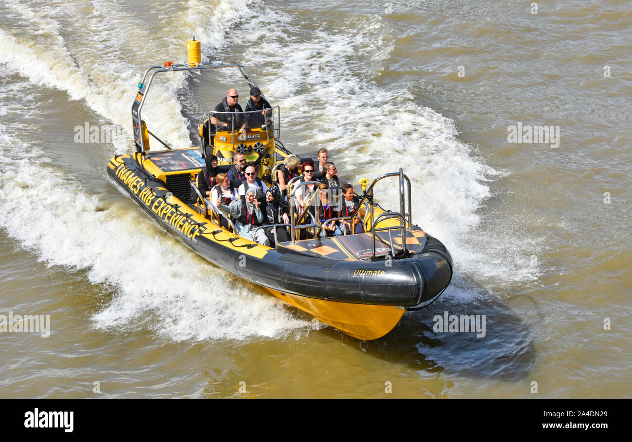 Looking down from above on group of tourist people in fast RIB rigid inflatable high speed boat sightseeing from River Thames in the Pool of London UK Stock Photo